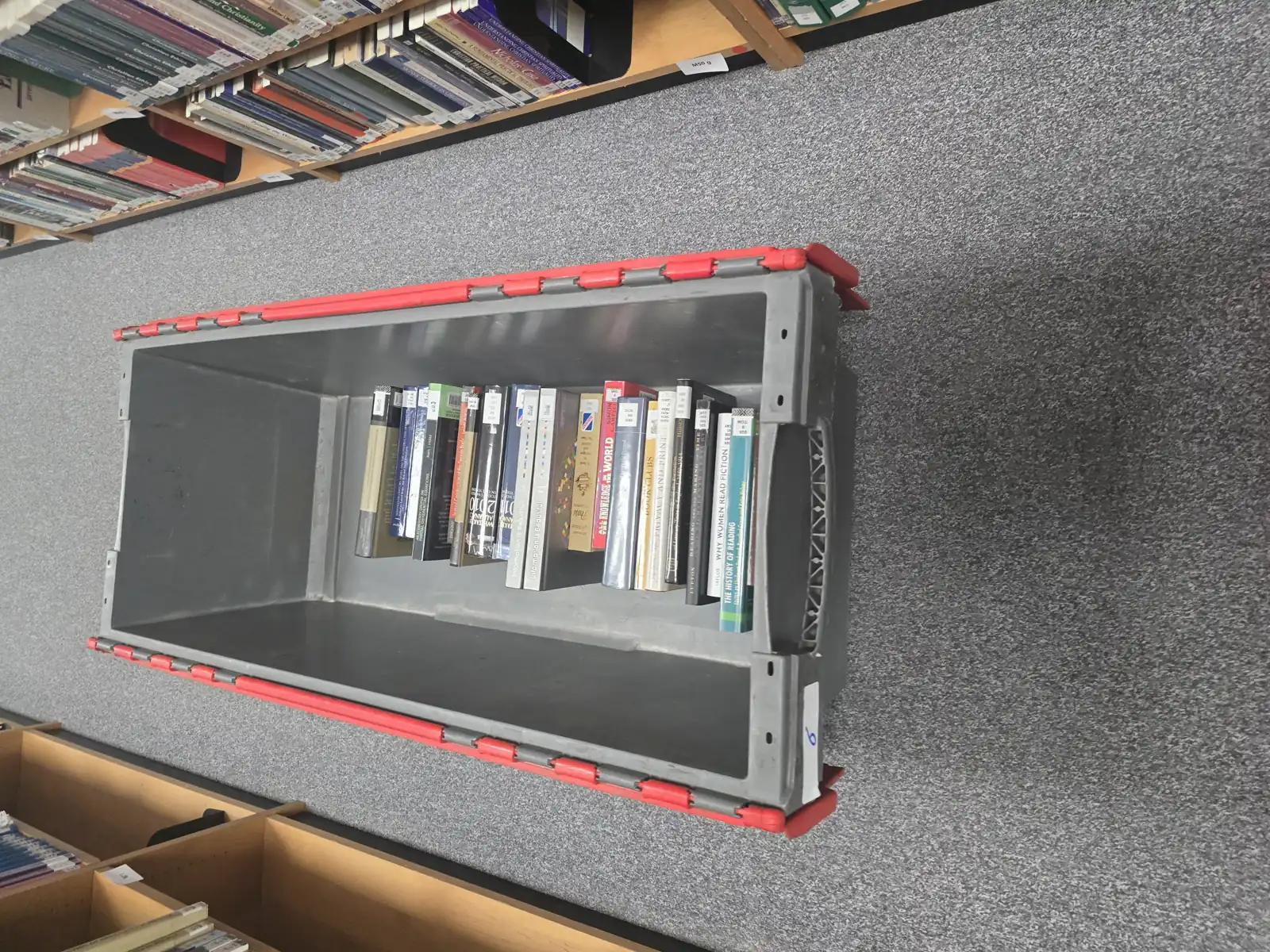 Library books packed into a crate in shelf order