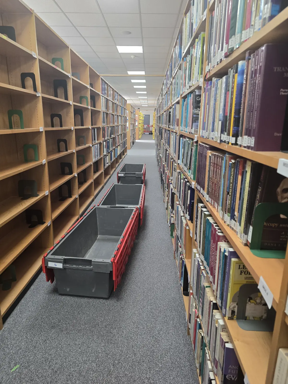 Crates staged down a library aisle