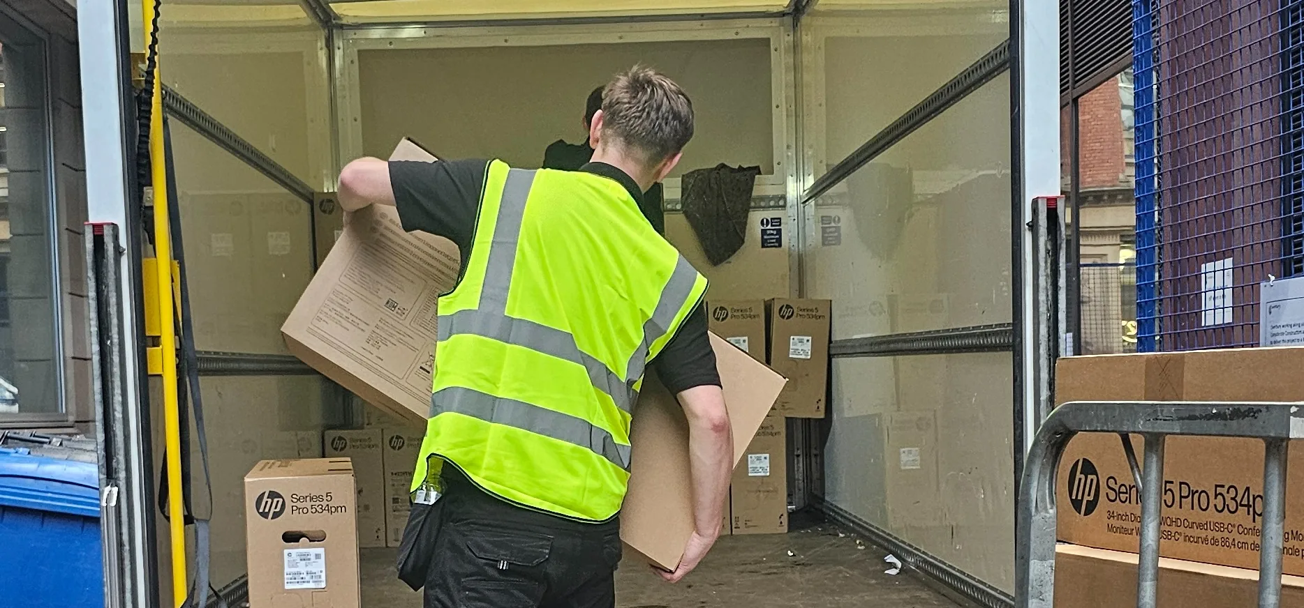 ReloCore UK crew loading boxes into a Luton van outside a Manchester office